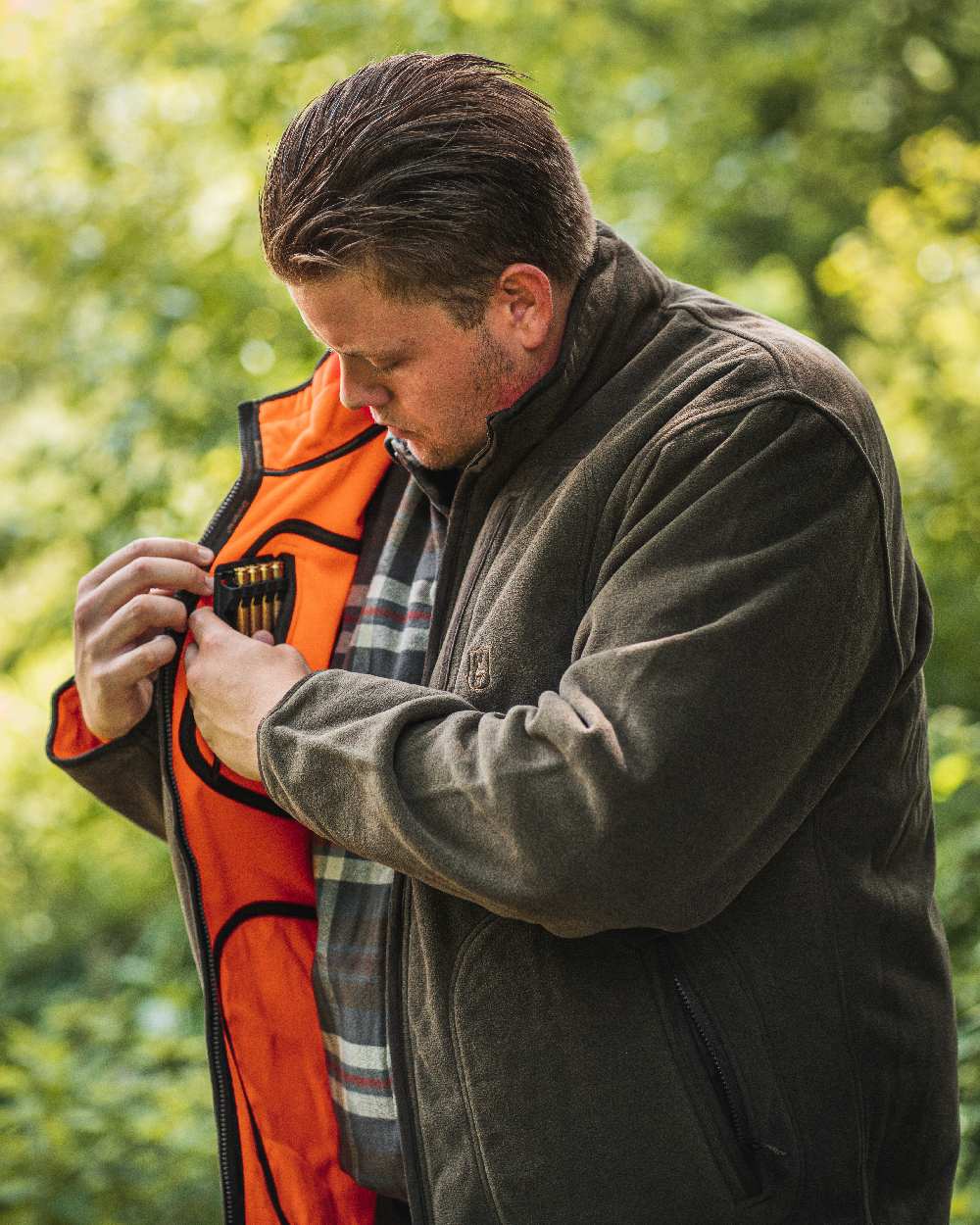 Canteen Orange coloured Deerhunter Gamekeeper Reversible Bonded Fleece Jacket on blurry background