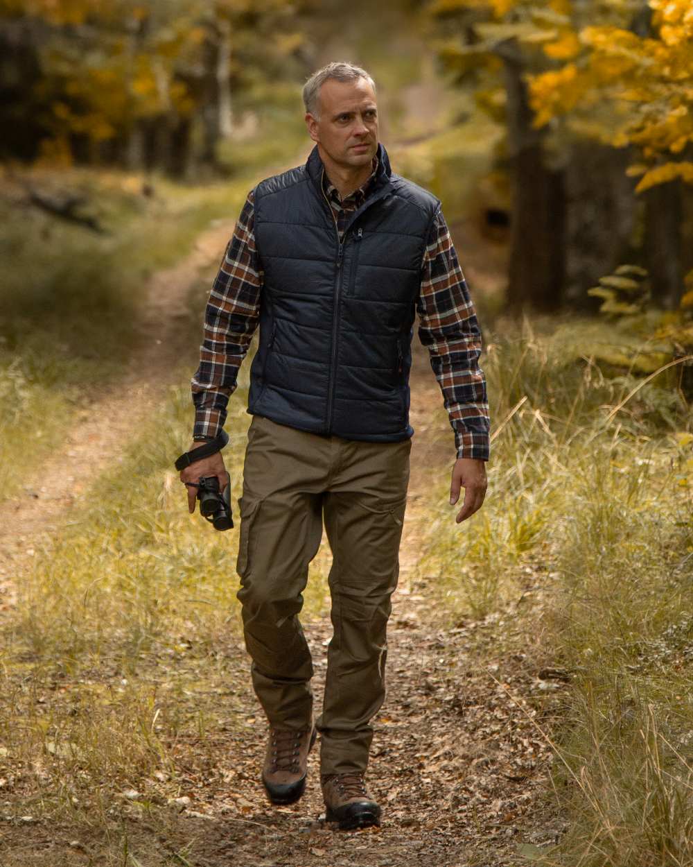 Dark Blue Coloured Deerhunter Heat Padded Waistcoat on forest background