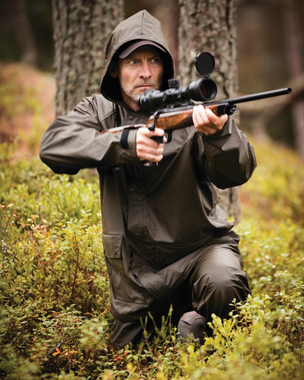 Art Green coloured Deerhunter Hurricane Rain Jacket on forest background