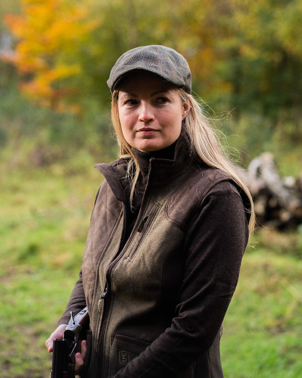 Graphite Green coloured Deerhunter Lady Pam Shooting Waistcoat on blurry background