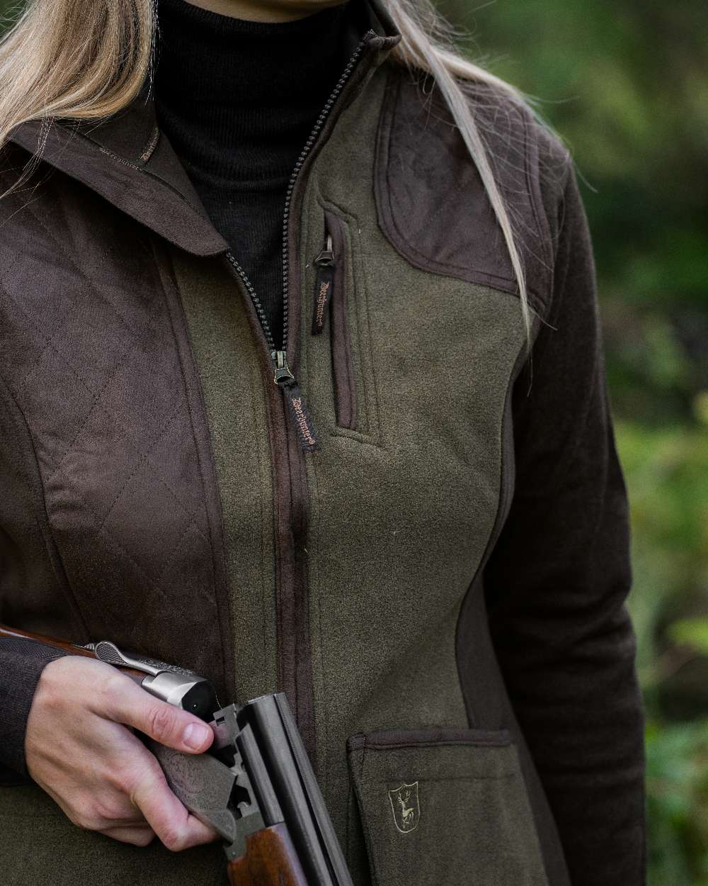 Graphite Green coloured Deerhunter Lady Pam Shooting Waistcoat on blurry background