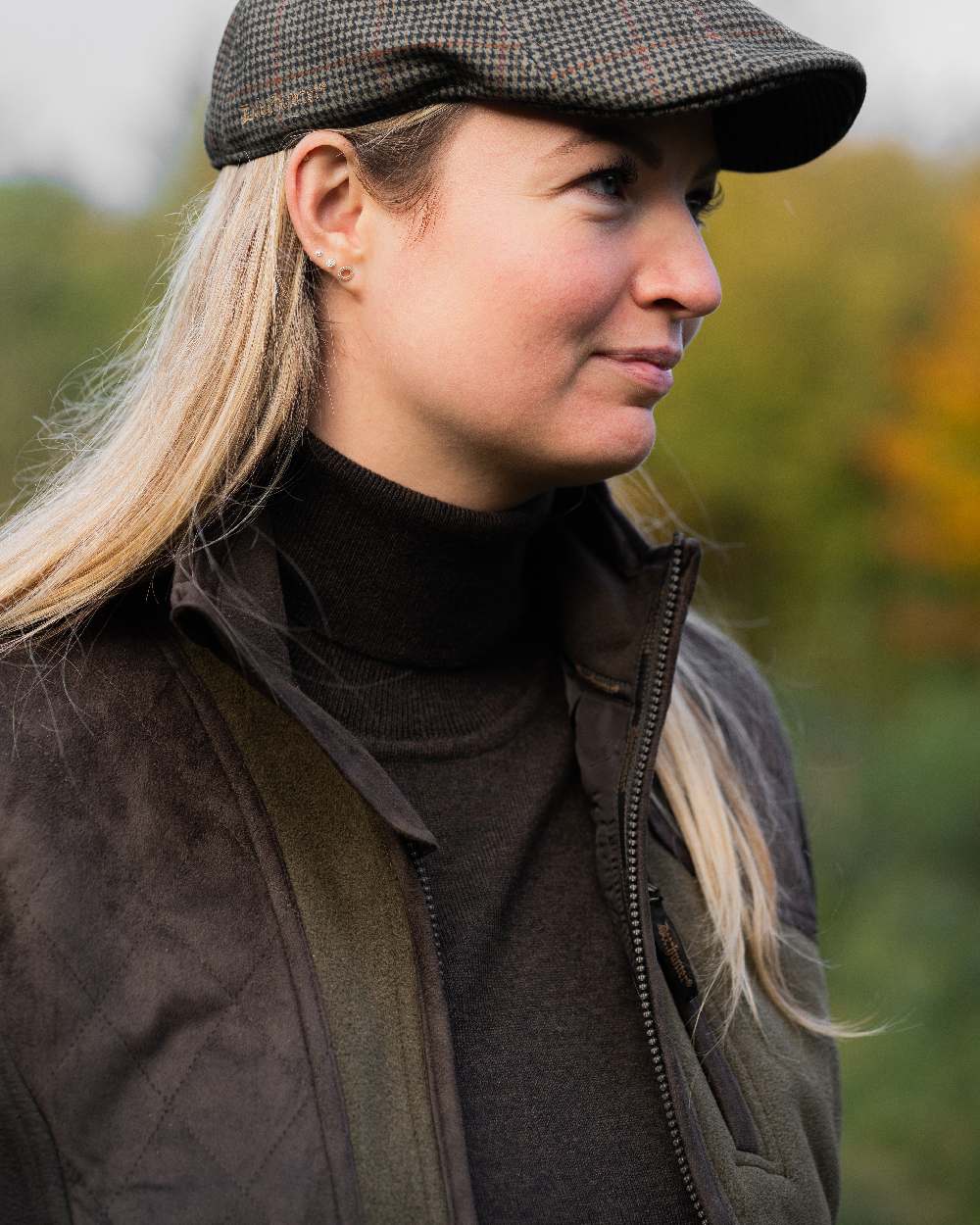 Graphite Green coloured Deerhunter Lady Pam Shooting Waistcoat on blurry background