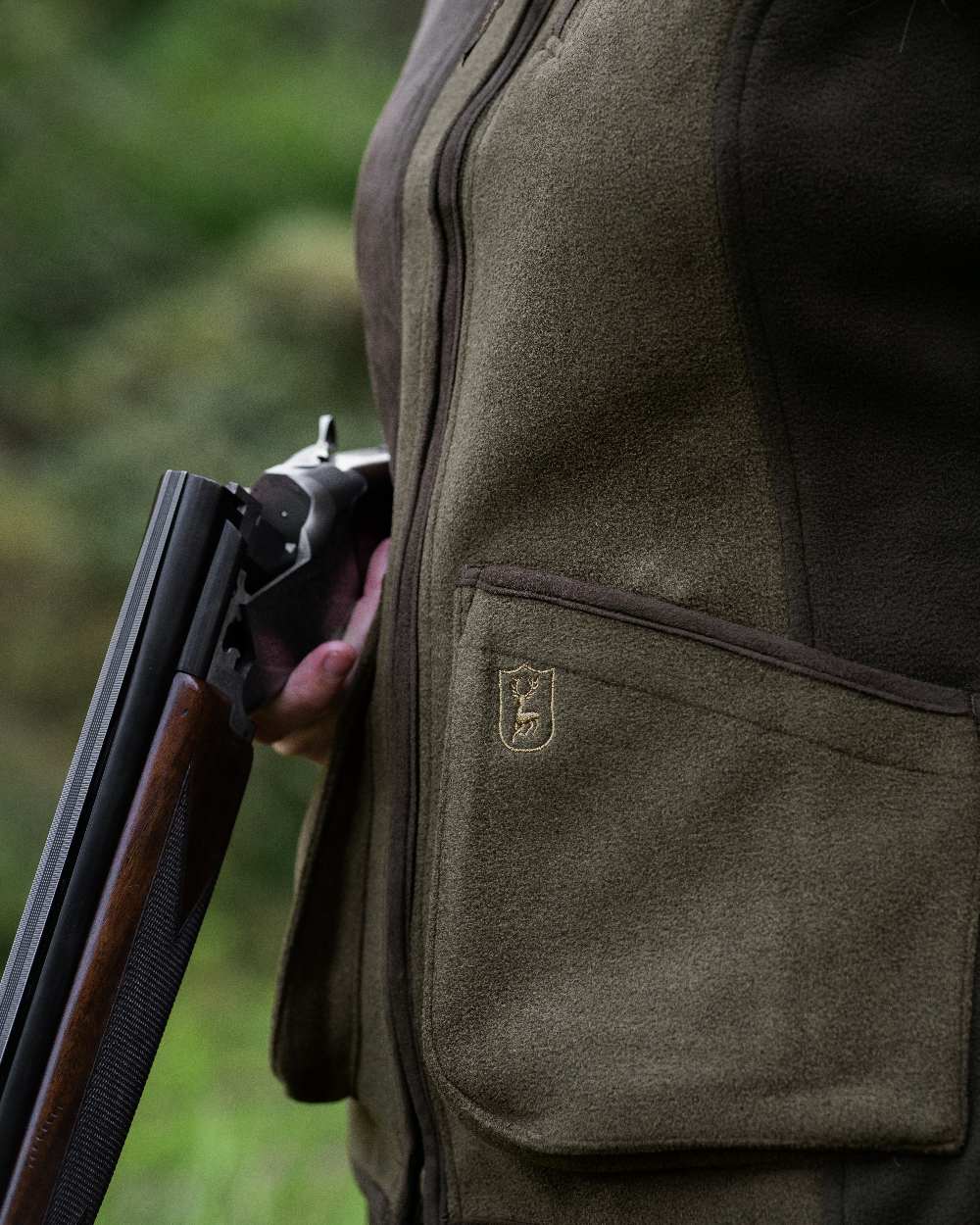 Graphite Green coloured Deerhunter Lady Pam Shooting Waistcoat on blurry background