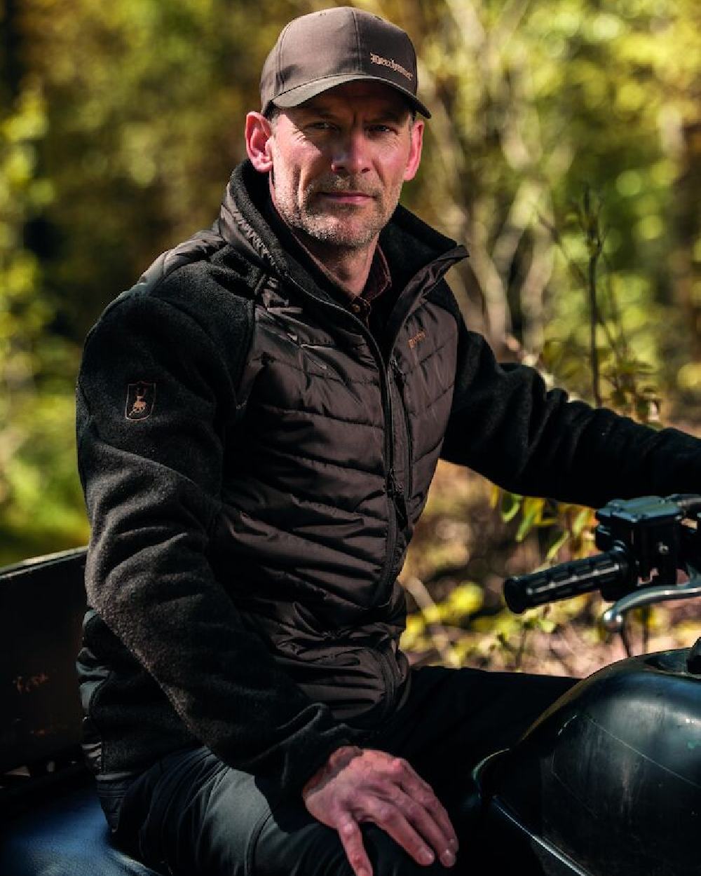 Timber Coloured Deerhunter Moor Padded Jacket with Knitted Sleeves on blurry background