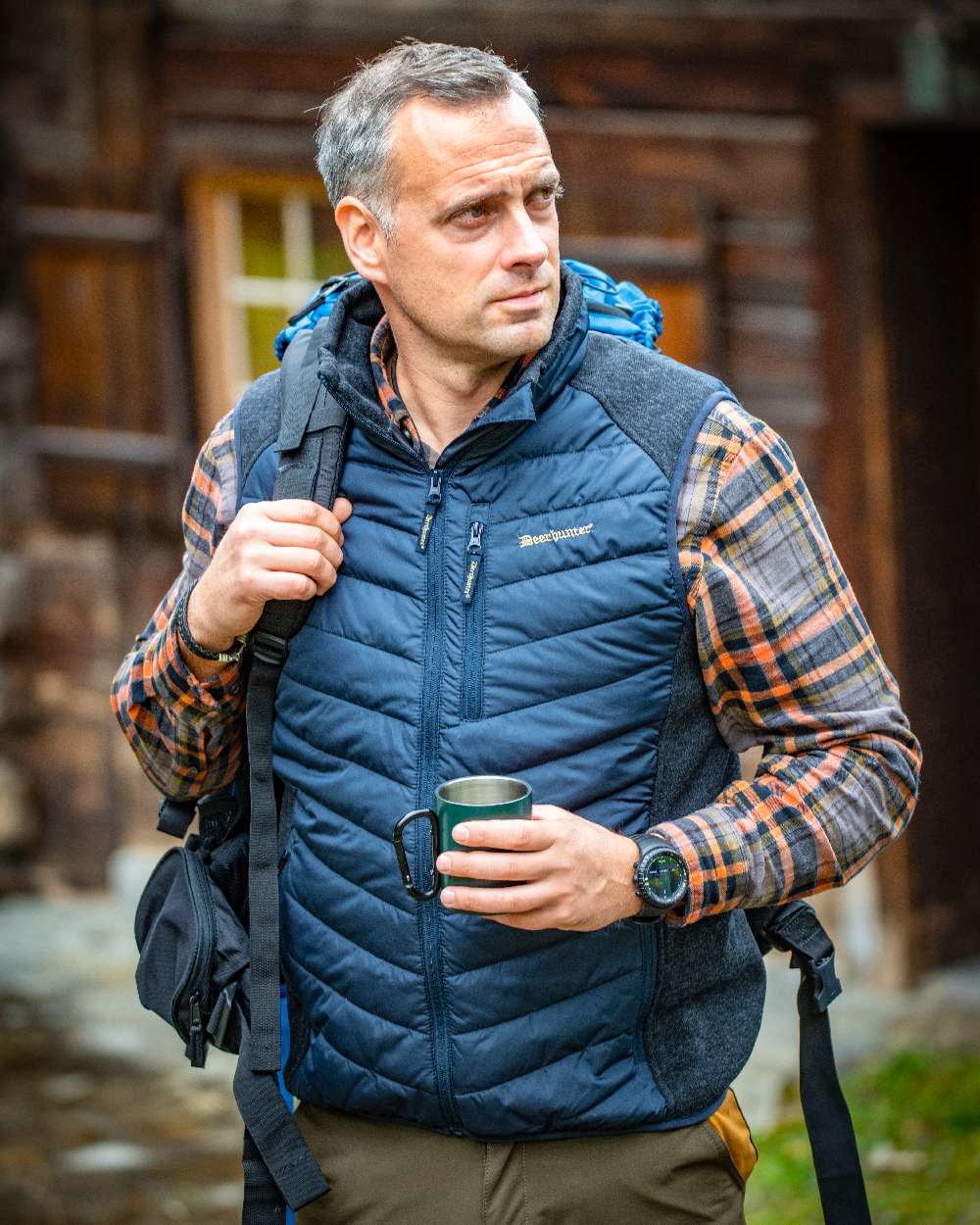 Dark Blue Coloured Deerhunter Moor Padded Waistcoat with Knit on blurry background