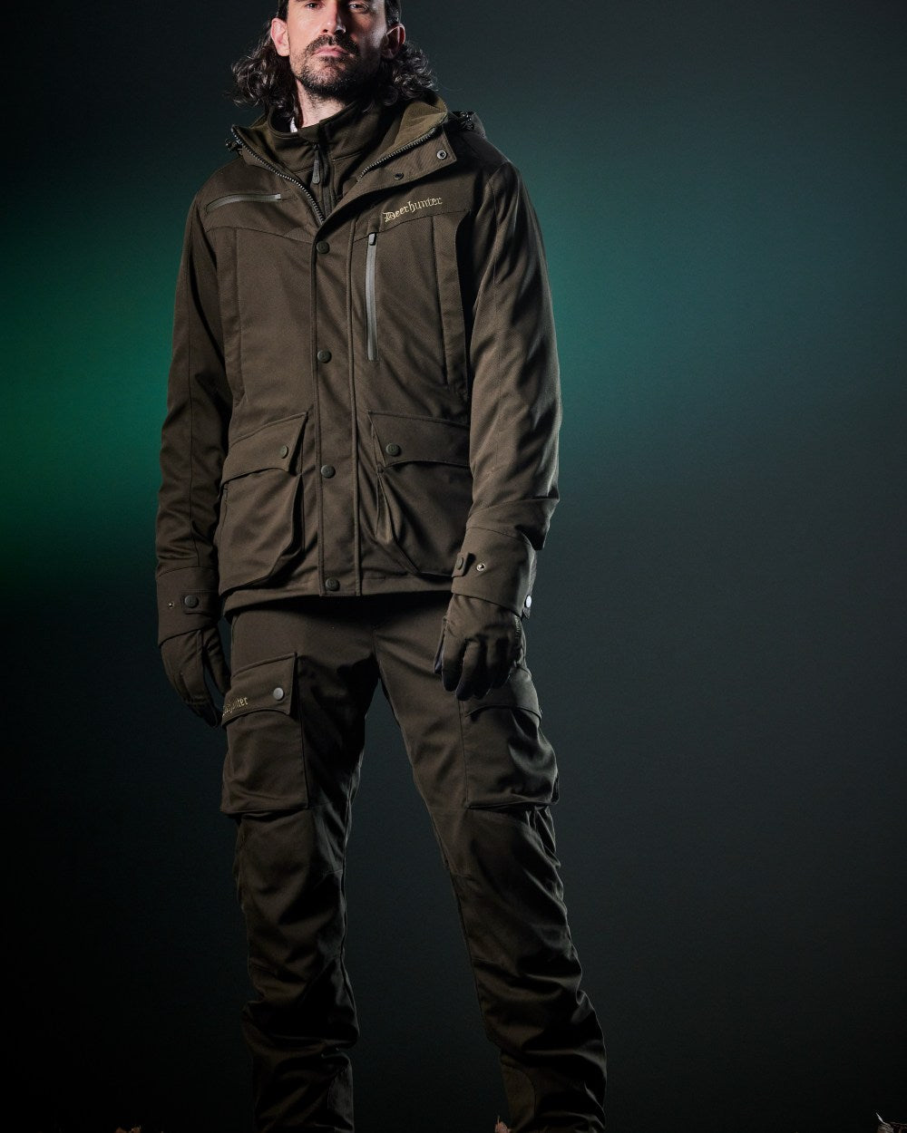 Art Green coloured Deerhunter Mens Muflon Pro Light Trousers on forest background