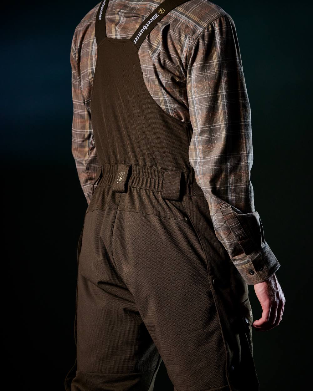 Art Green coloured Deerhunter Mens Muflon Pro Winter Bib Trousers on forest background