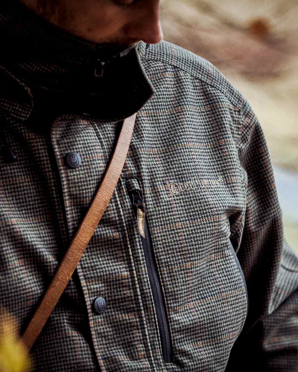 Turf Coloured Deerhunter PRO Gamekeeper Jacket on blurry background