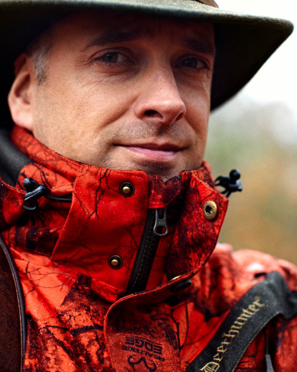 Realtree Edge Red coloured Deerhunter Ram Arctic Jacket on blurry background