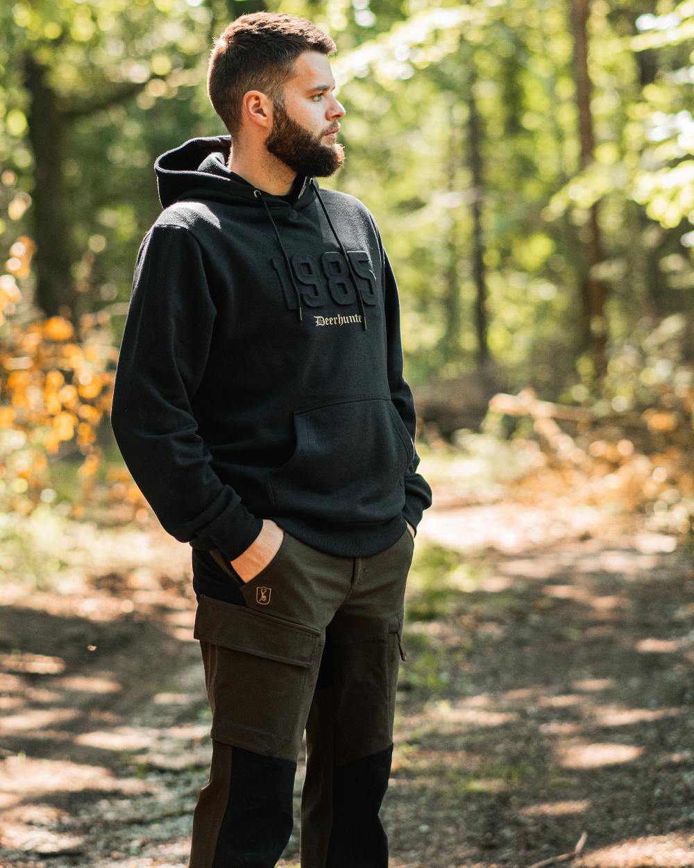 Fallen Leaf Black coloured Deerhunter Sarek Full Stretch Trousers on forest background