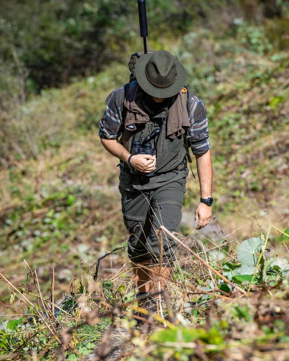 Palm Green coloured Deerhunter Strike Extreme Trousers on forest background