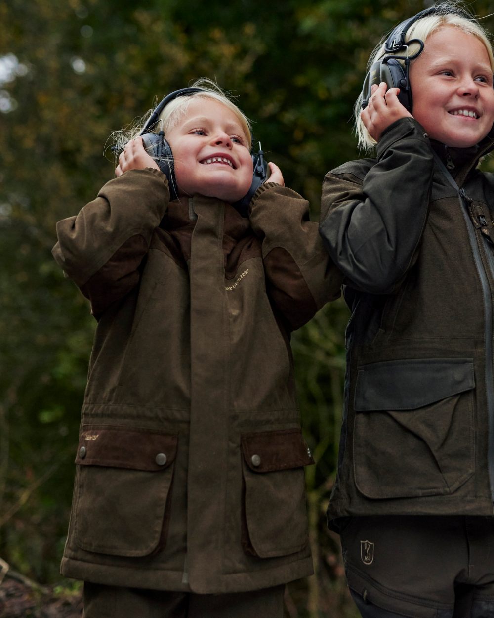 Tarmac Green coloured Deerhunter Youth Eagle Winter Jacket on Forest background