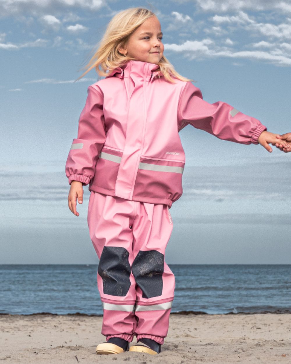 Light Heather Pink coloured Didriksons Boardman Kids Rain Set on sea background
