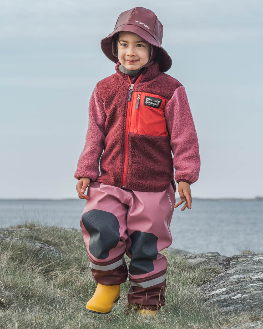 Anemon Red coloured Didriksons Childrens Anten Full Zip Jacket on sea background