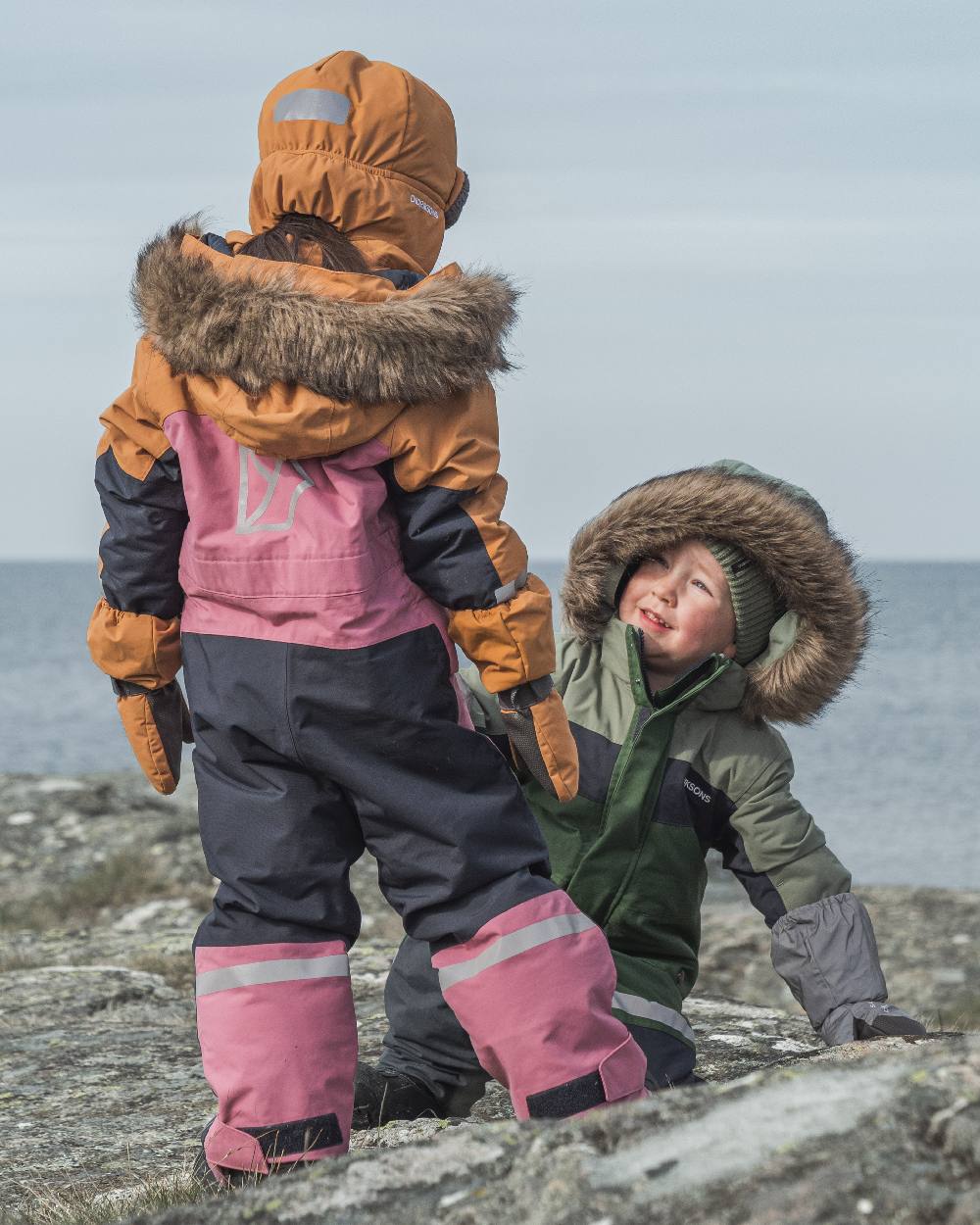 Heather Pink Coloured Didriksons Childrens Bjärven Coveralls on outdoor background