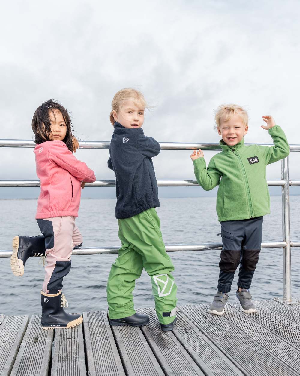 Dark Night Blue coloured Didriksons Childrens Muskot Jacket on sea background