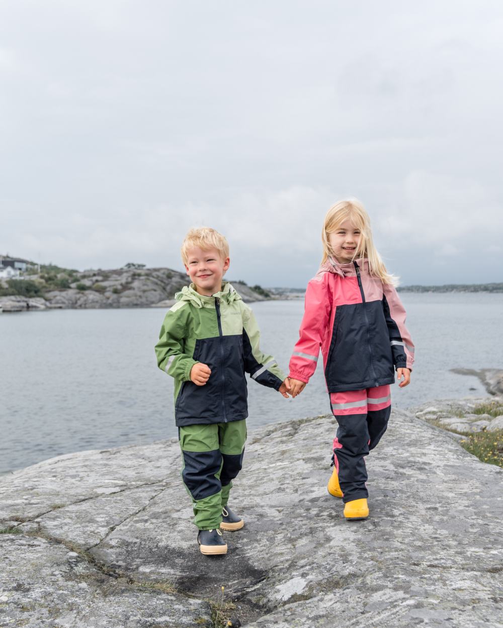 Light Algae Green coloured Didriksons Childrens Pilvi Jacket on coastal background