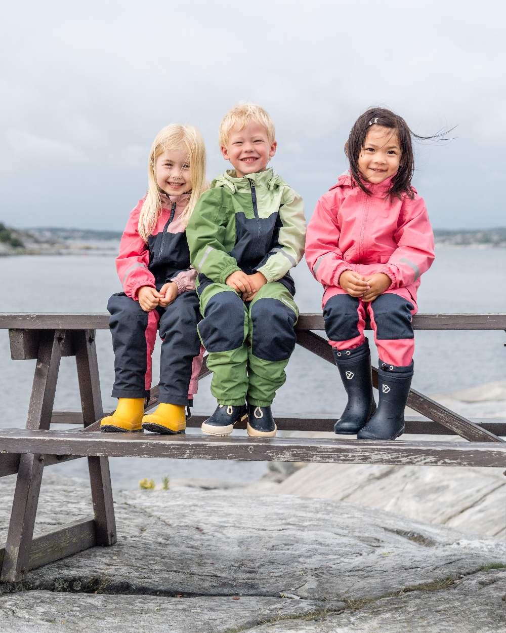 Light Algae Green coloured Didriksons Childrens Pilvi Jacket on coastal background