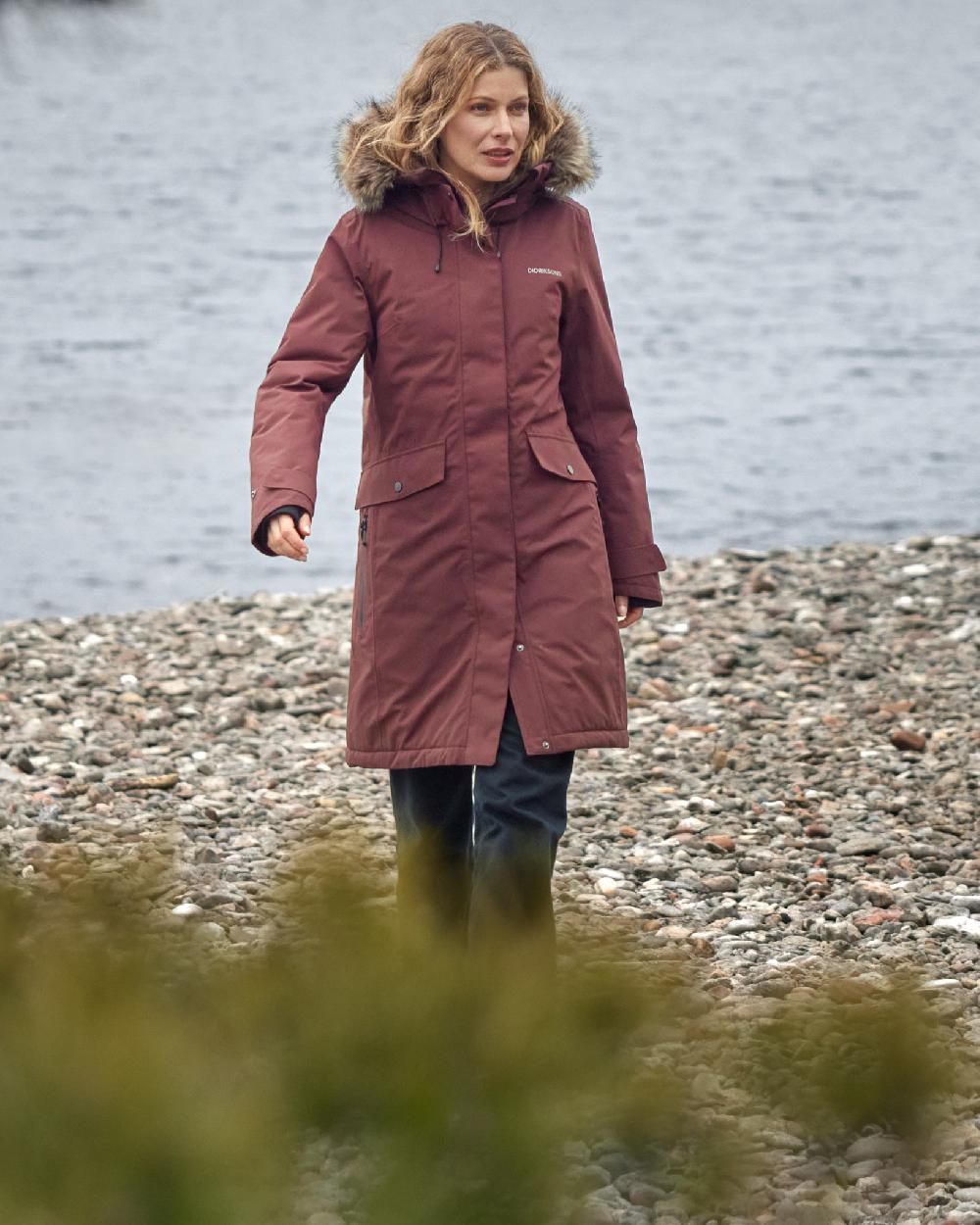 Old Rust Coloured Didriksons Erika Ladies Padded Waterproof Parka 3 On A Coastal Background