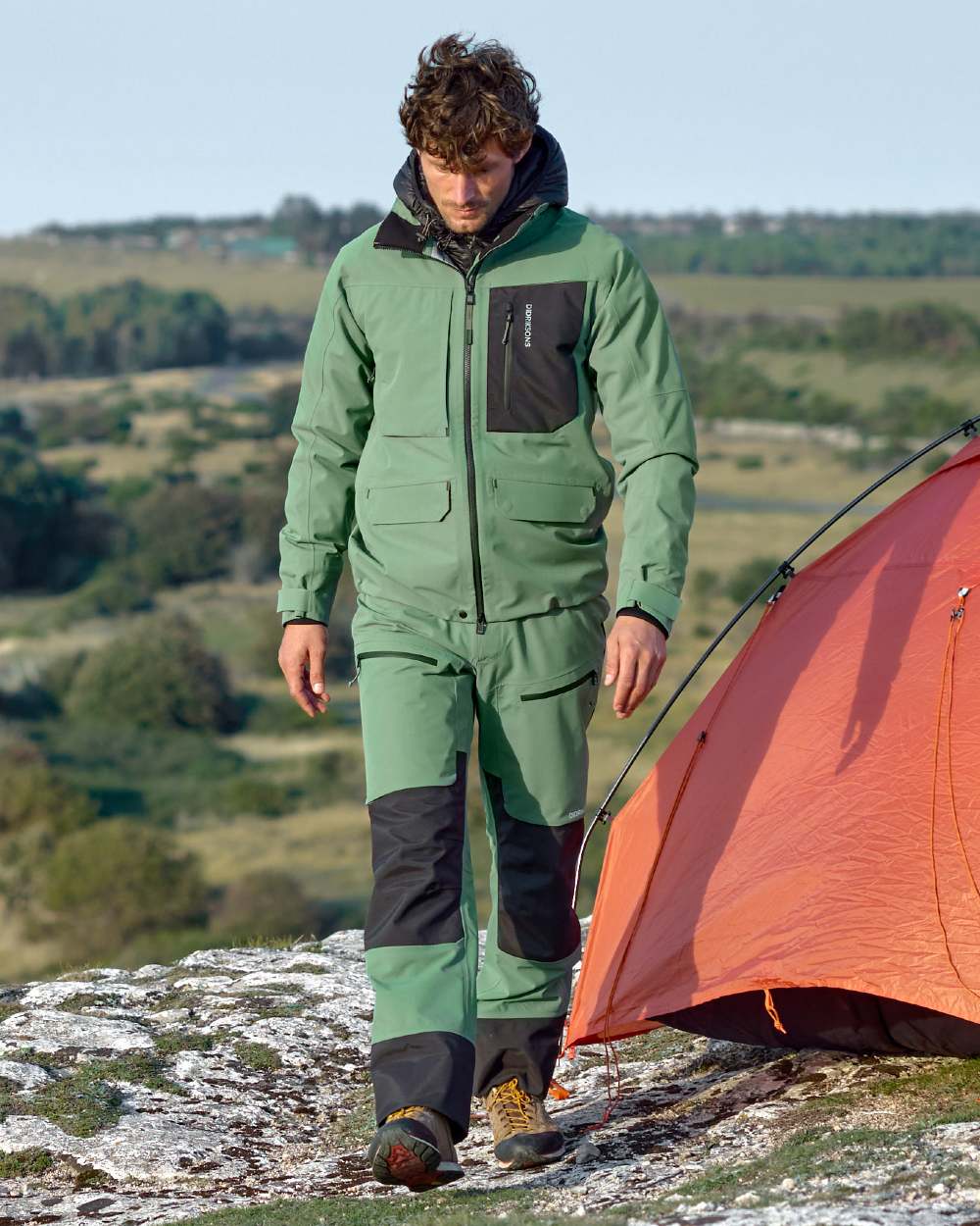 Dark Moss coloured Didriksons Fractus Waterproof Jacket on sea background