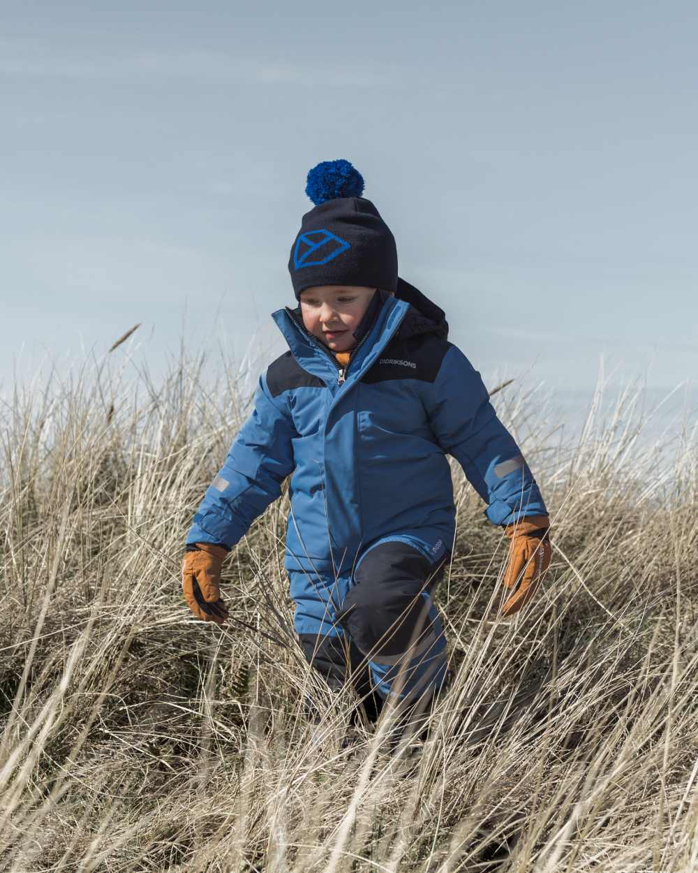 Sapphire Blue Coloured Didriksons Kids Skare Set on mountain background