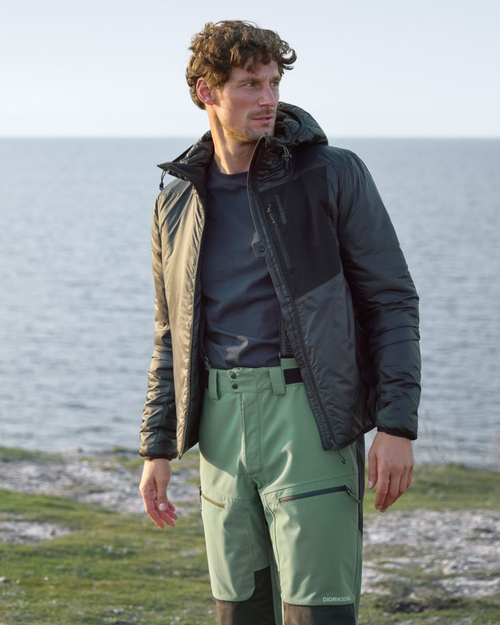 Black coloured Didriksons Mens Sander Jacket on sea background