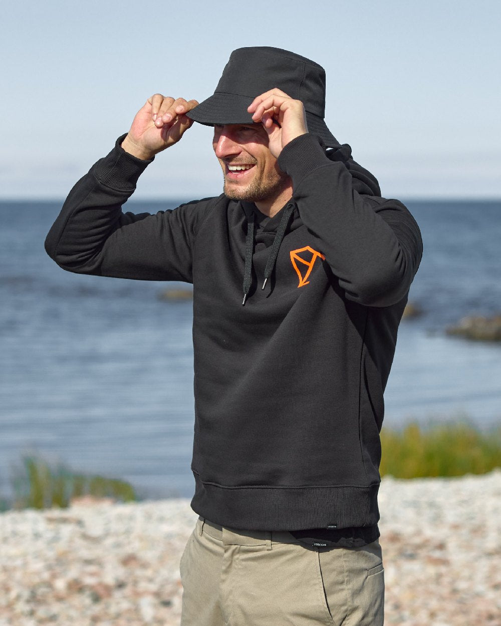 Black coloured Didriksons Solomon Bucket Hat on sea background