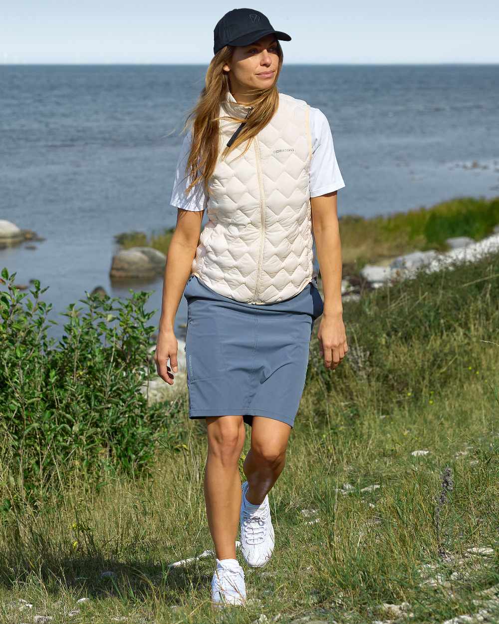 White Foam coloured Didriksons Womens Evy Vest on sea background
