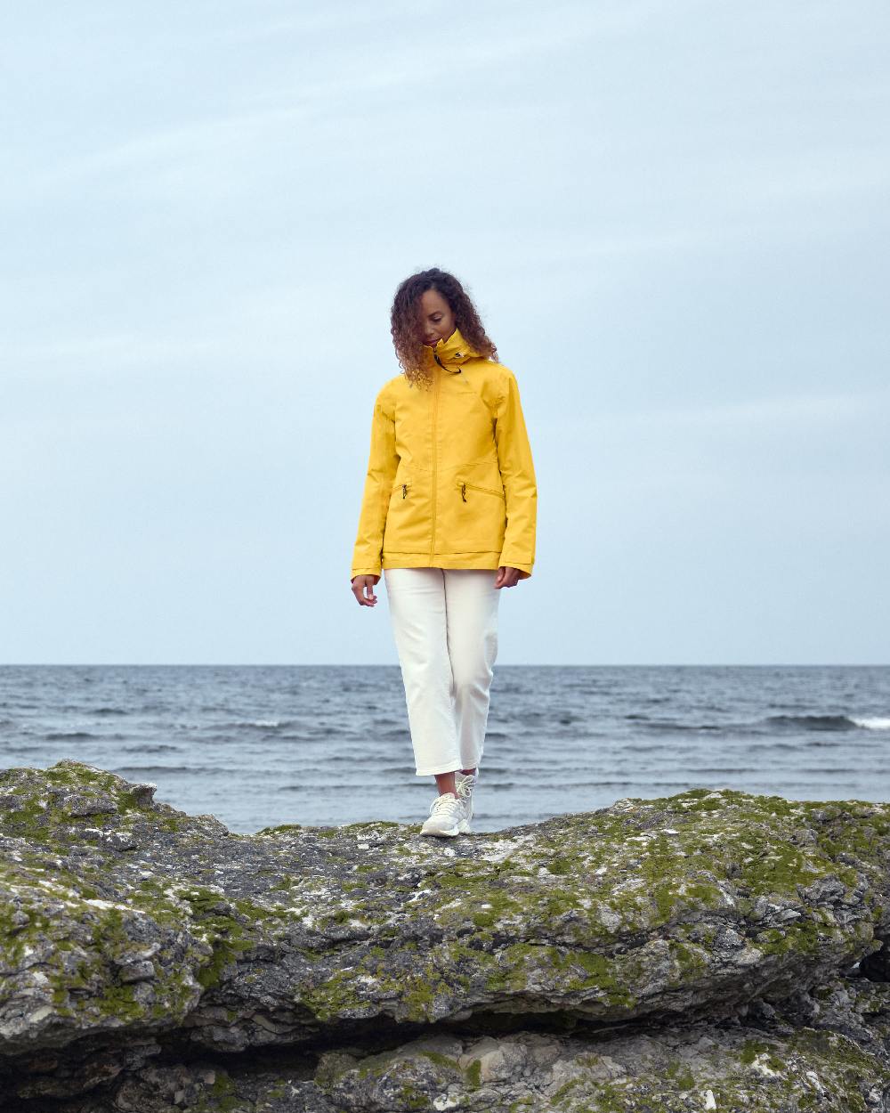 Warm Yellow coloured Didriksons Womens Turvi Jacket 2 on sky background