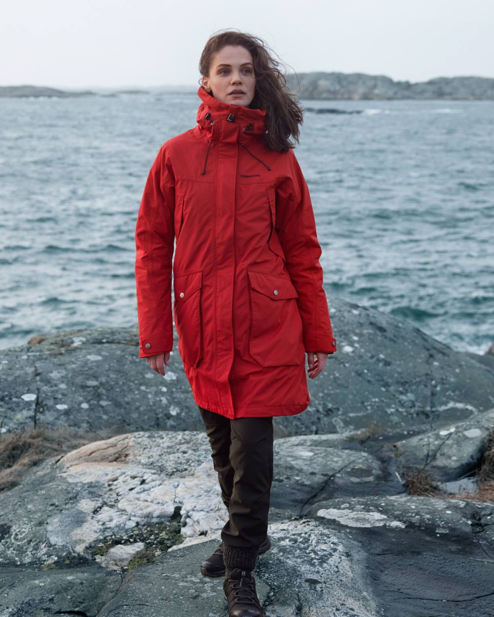 Pomme Red Coloured Didriksons Thelma Womens Parka 10 On A Coastal Background