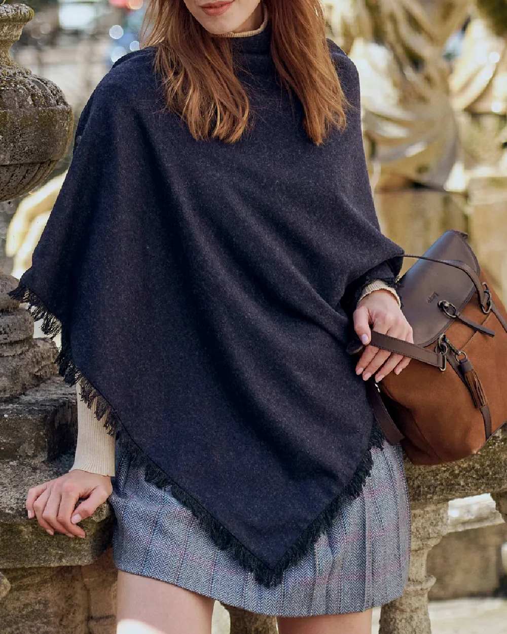 Navy Coloured Dubarry Hazelwood Tweed Poncho on wall background