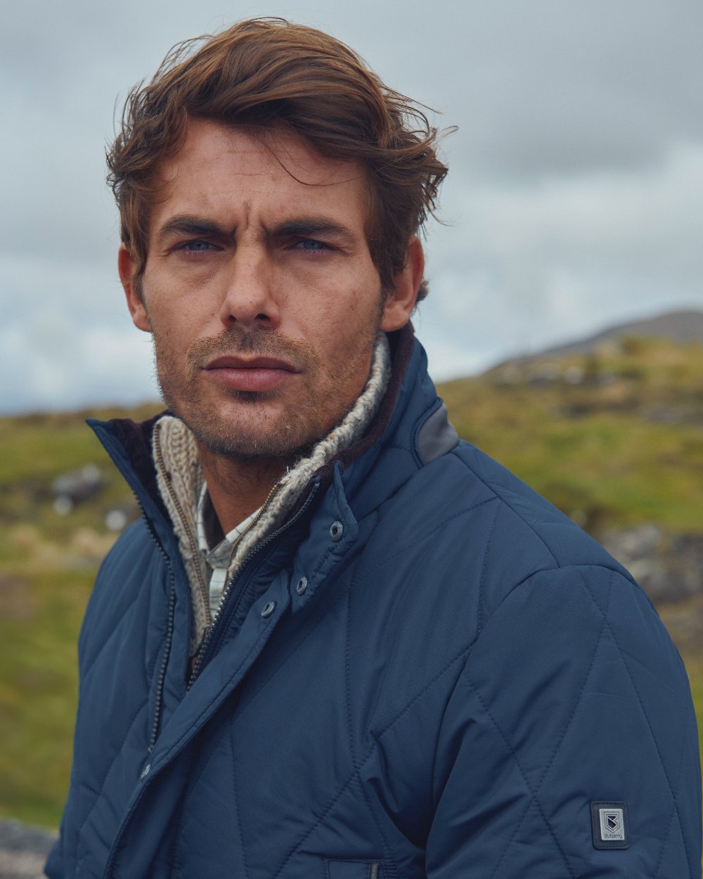 Navy Coloured Dubarry Mens Farmley Quilted Jacket on blurry background