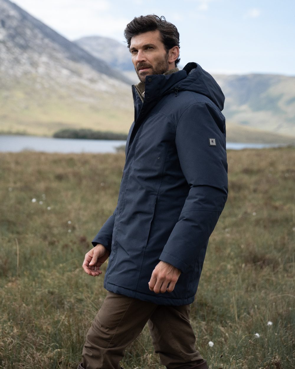 Navy Coloured Dubarry Mens Swiftsheath Waterproof Hooded Down Parka on outdoor background