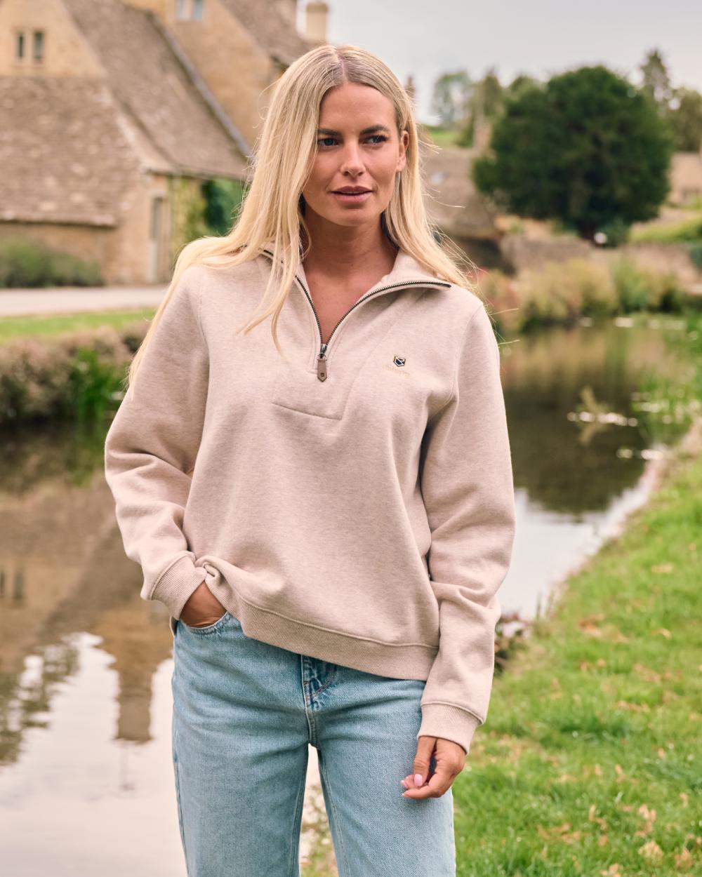 Bone coloured Dubarry Womens Castlemartyr Quarter Zip Sweatshirt on backyard background