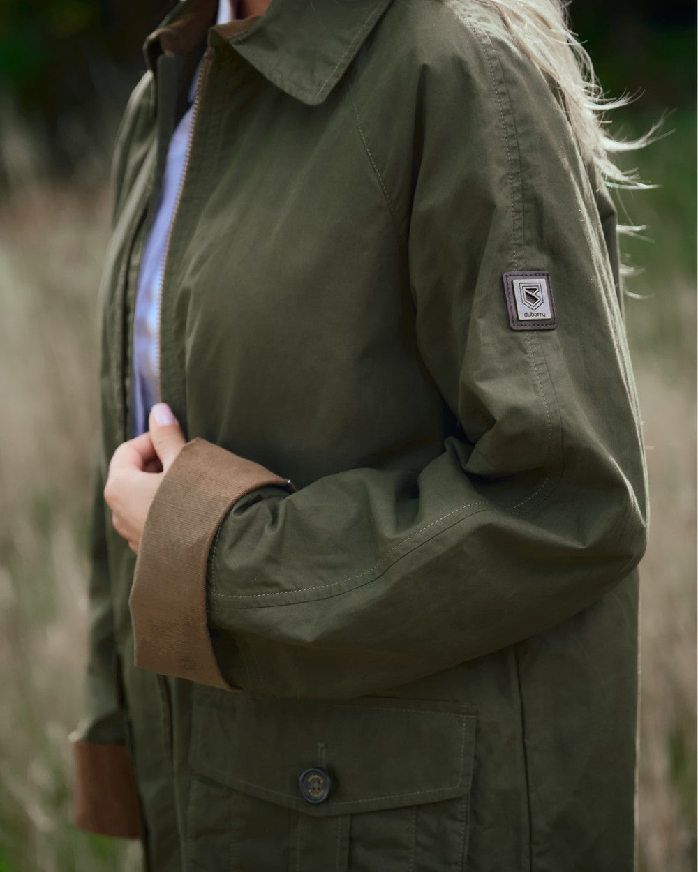 Dusky Green coloured Dubarry Womens Delaney Waxed Cotton Utility Jacket on blurry background