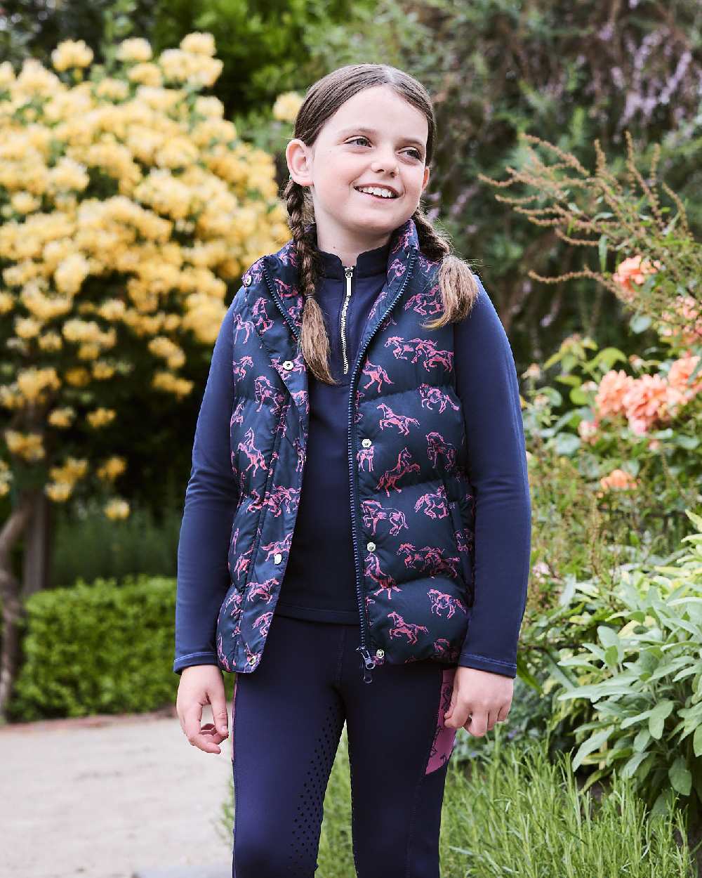 Navy Frolicking Horses coloured Dublin Childrens Patrice Everyday Puffer Vest on Plants background