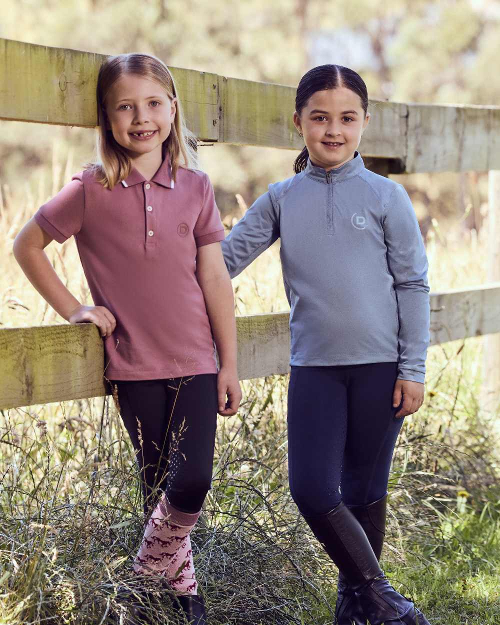 Blue Fog coloured Dublin Kids Breathable Long Sleeve Riding Top on grassy background