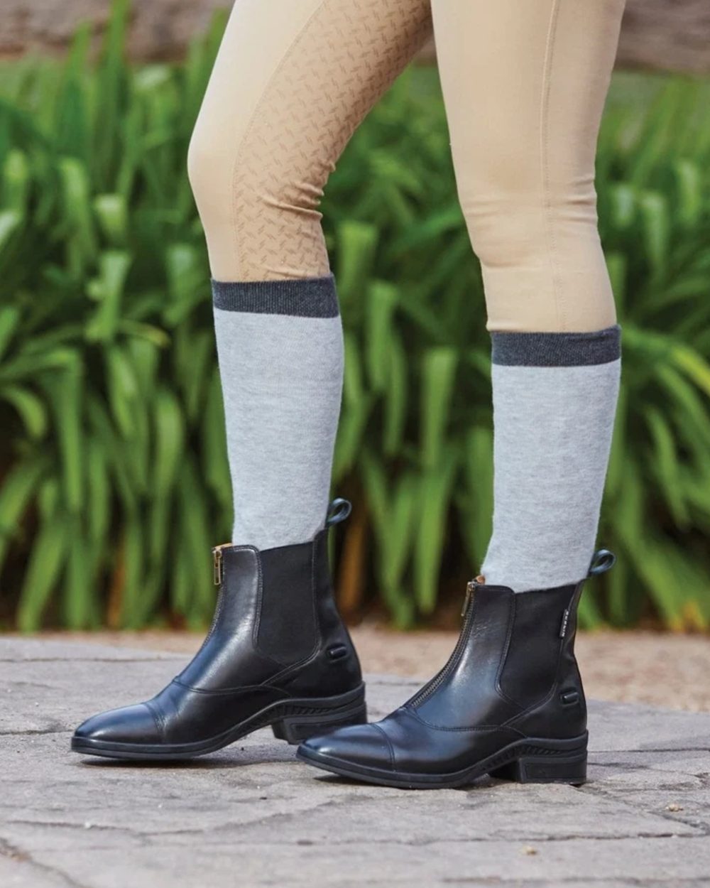 Black coloured Dublin Paramount Zip Paddock Boots on garden background