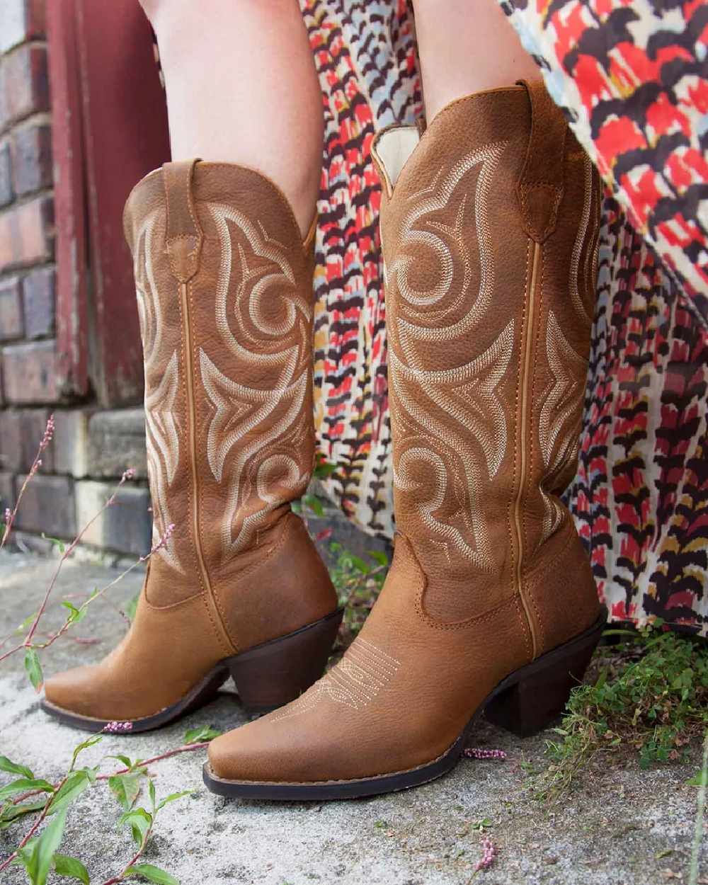 Distressed Cognac coloured Durango Womens Crush Western Fashion Booties on street background