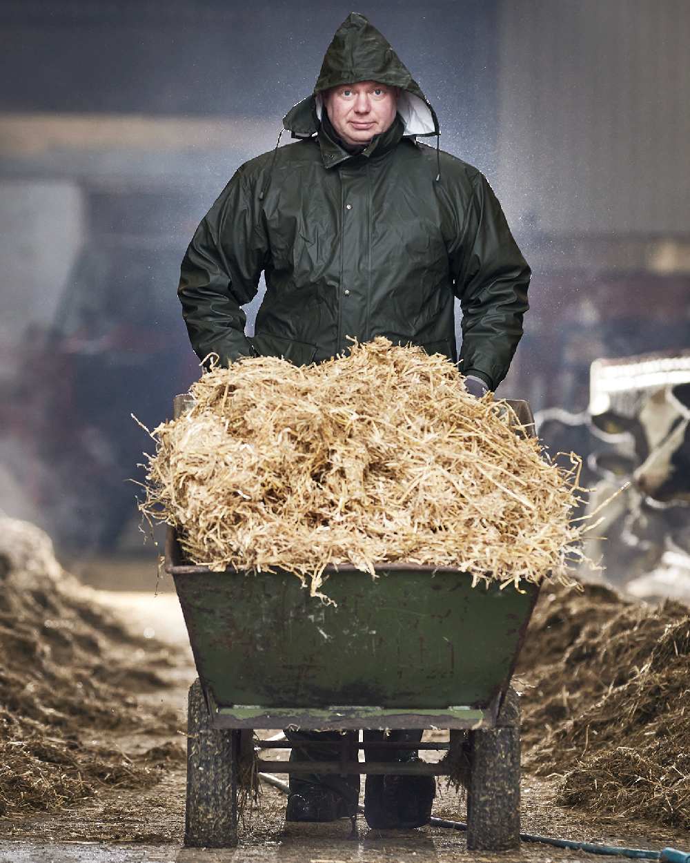 Olive Coloured Elka Mens Dry Zone PU Rain Jacket on barn background