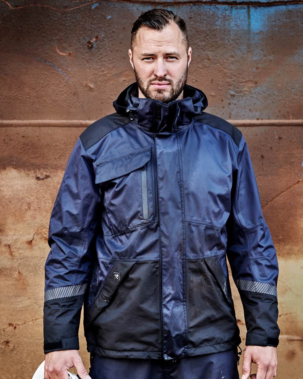 Navy Black Coloured Elka Mens Working Xtreme Stretch Jacket on construction background