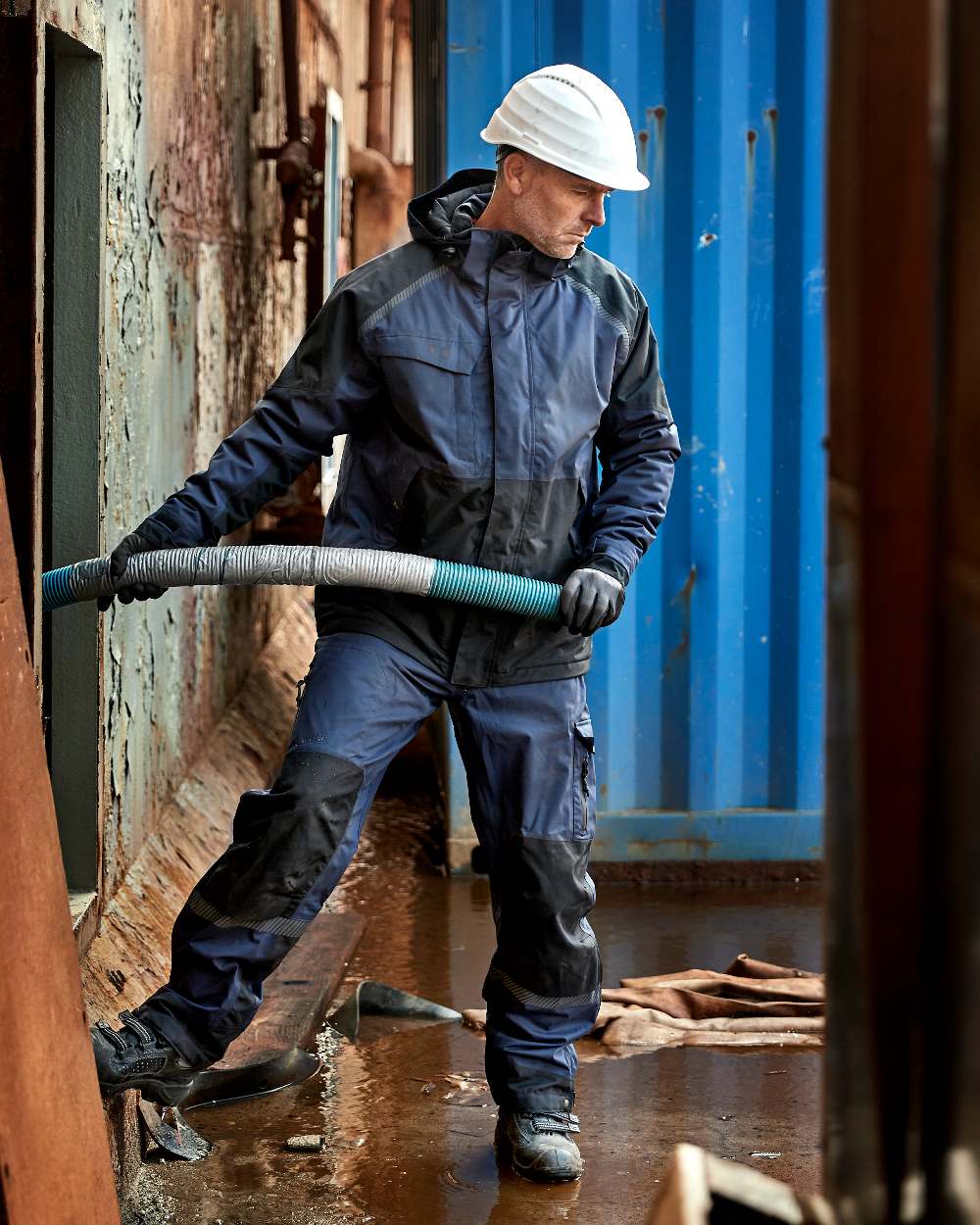 Navy Black Coloured Elka Mens Working Xtreme Stretch Winter Jacket on construction background