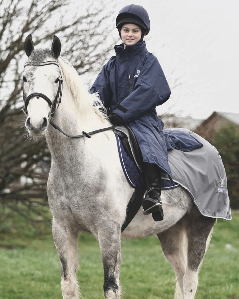 Navy coloured Equidry Children Pro Ride Evolution Thin Fleece With Stowaway Hood on outdoor background