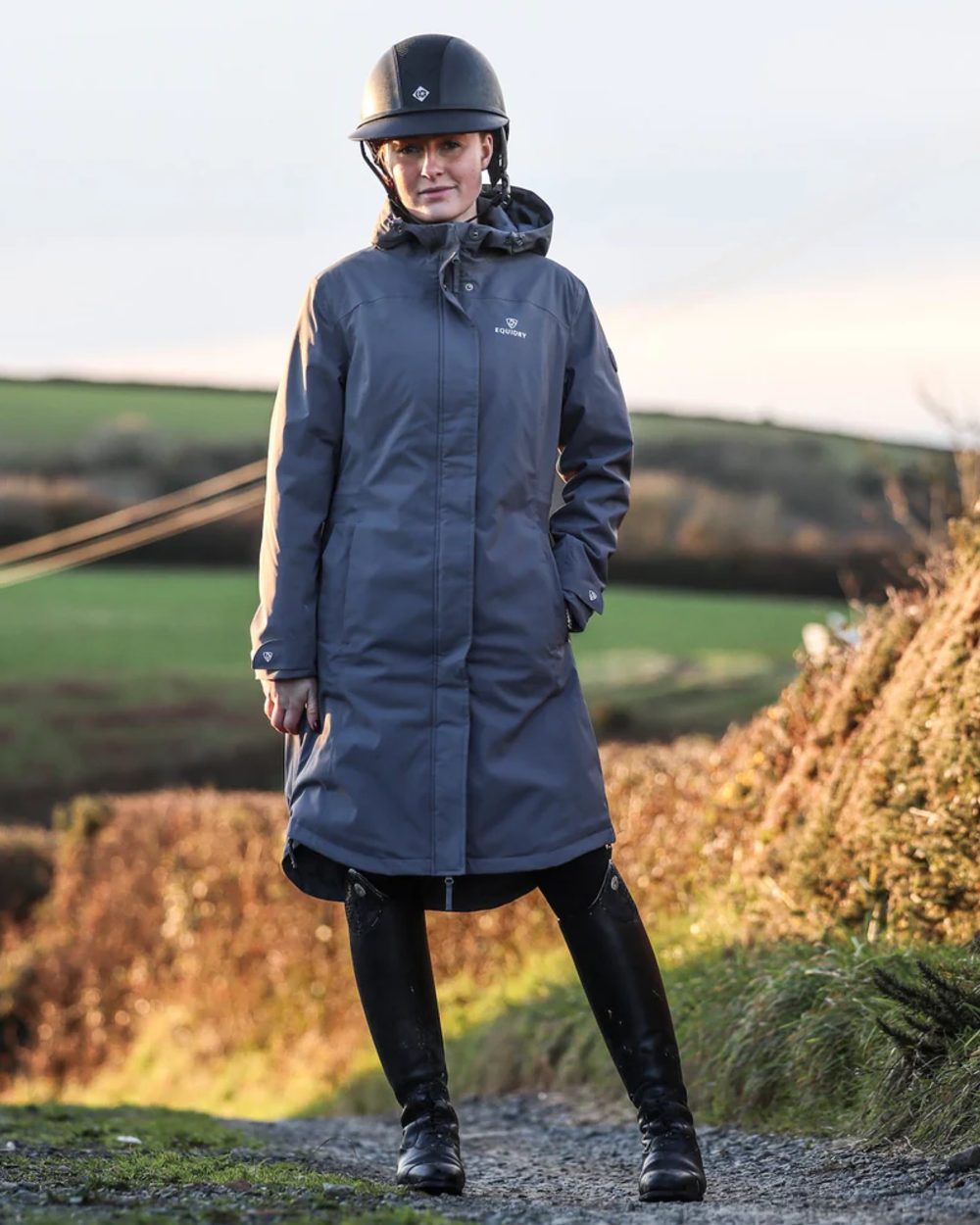 Charcoal coloured Equidry Childrens Bronte Riding Coat on farm background
