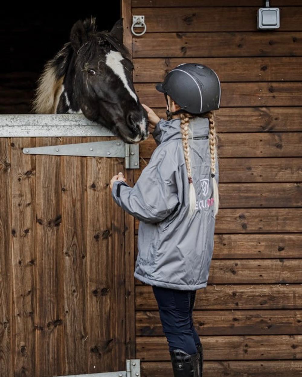 Charcoal Penelope Pink coloured Equidry Childrens Shortie Jacket on stable background