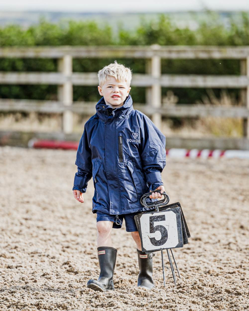 Navy coloured Equidry Childrens Shortie Jacket on street background