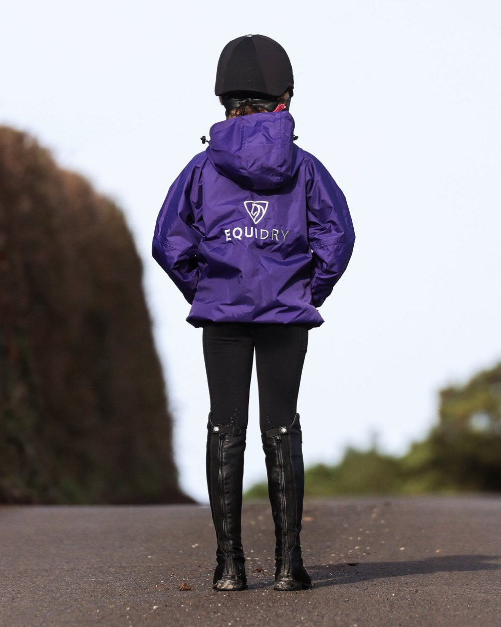 Purple coloured Equidry Childrens Shortie Jacket on street background