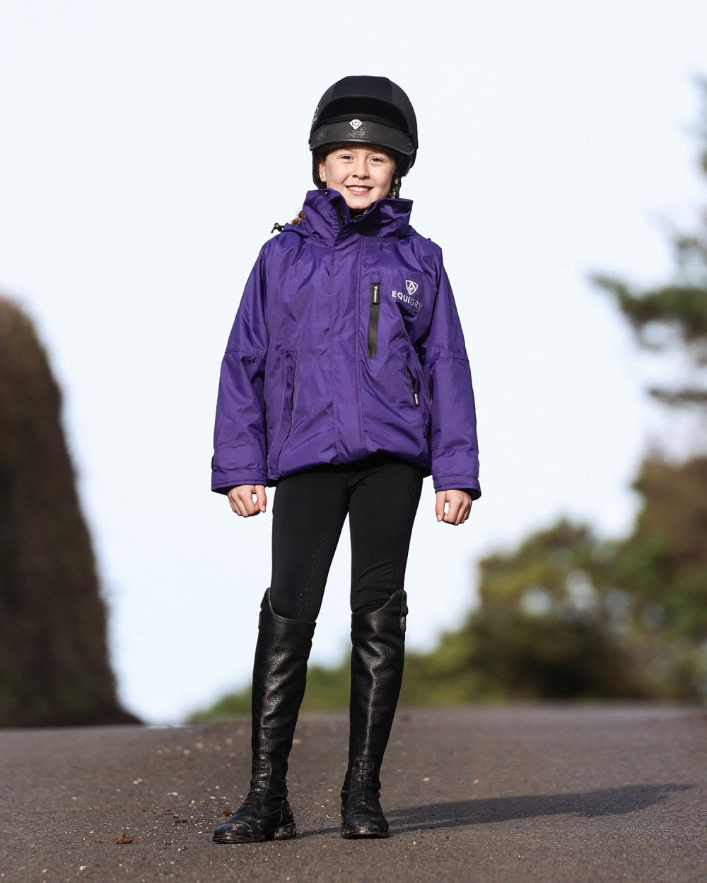 Purple coloured Equidry Childrens Shortie Jacket on street background