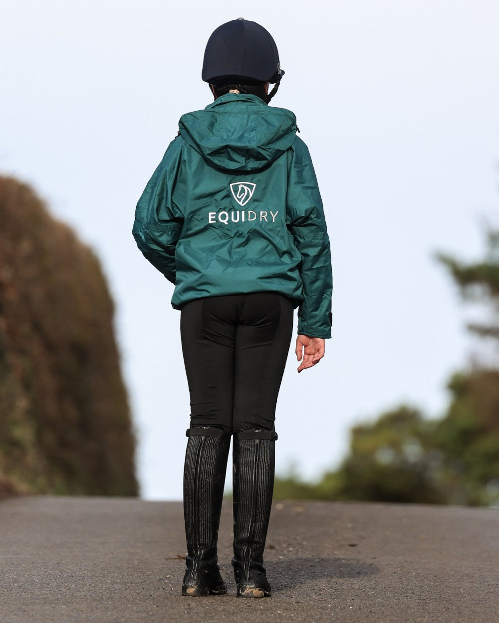 Teal coloured Equidry Childrens Shortie Jacket on street background