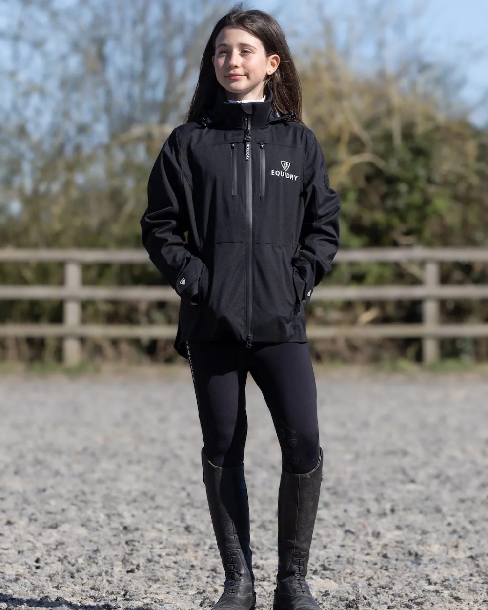 Black coloured Equidry Childrens Varsha Waterproof Jacket on farm background